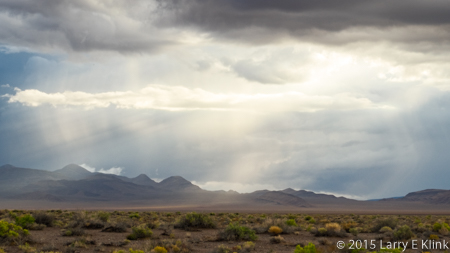 Image of rain and crepuscular rays over Nevada desert